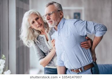 old women is helping old man in chronic pain
